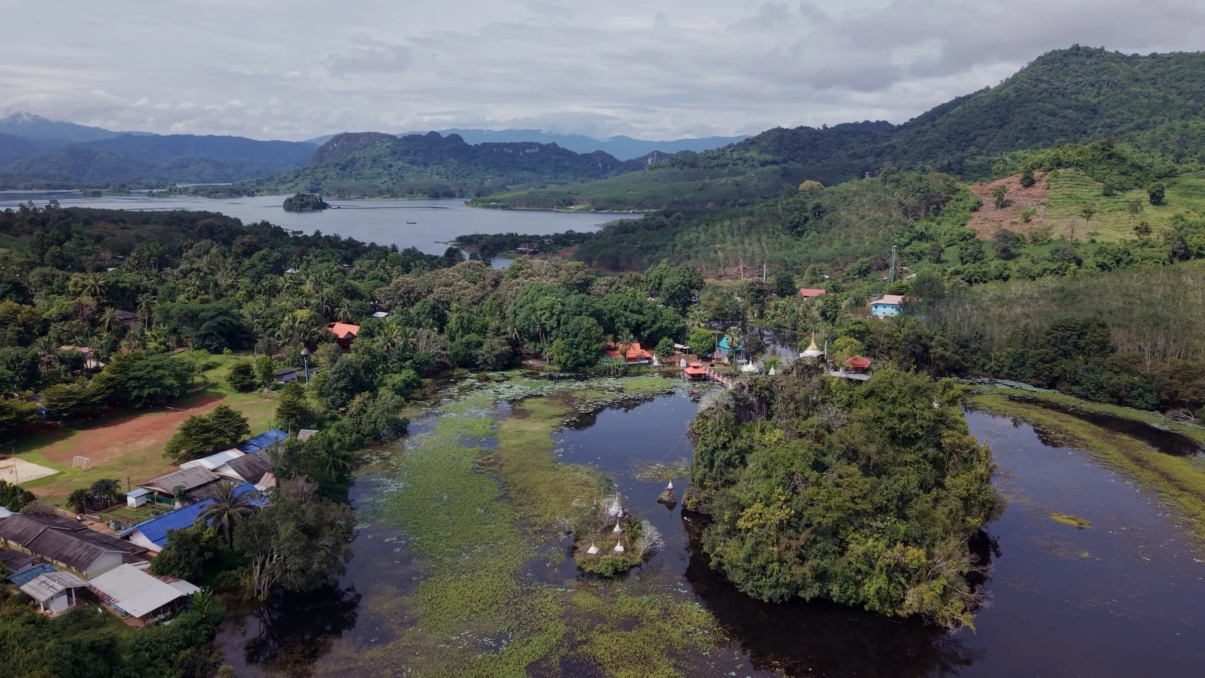 Aerial view of the flooded shoreline and green islands of Khao Laem Lake.