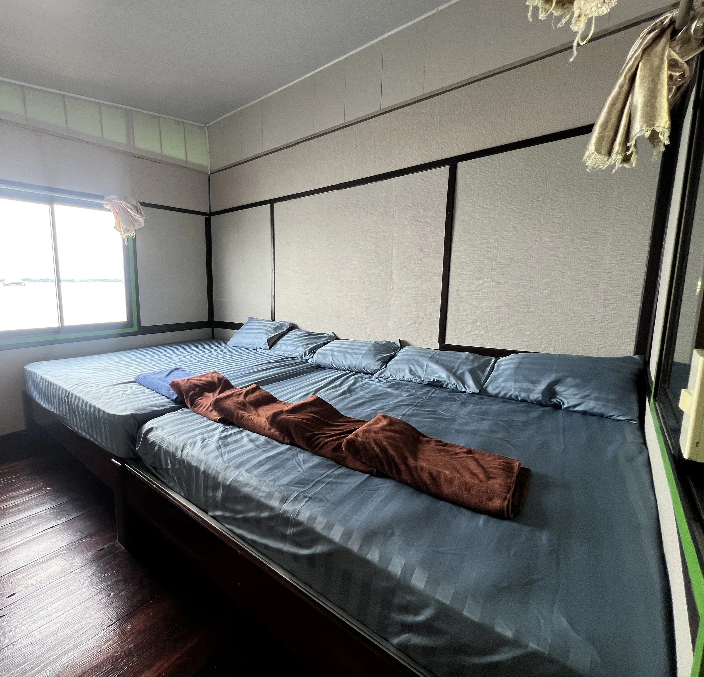 A private room with two mattresses made up side by side on a low wooden platform.