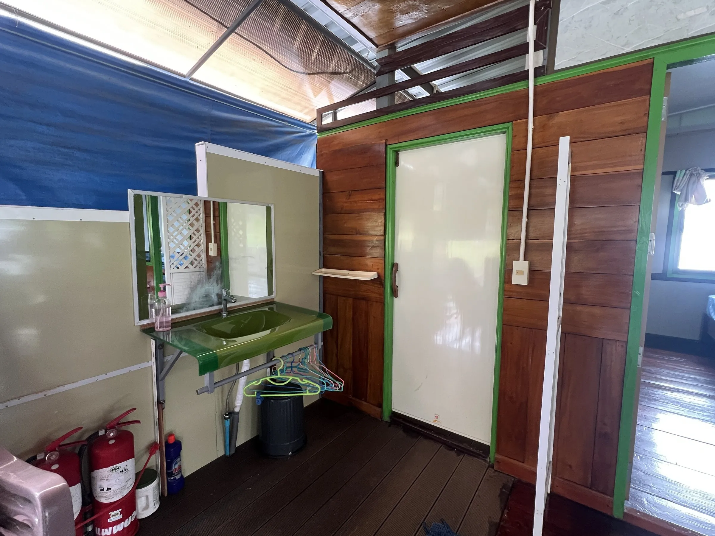 The washing area on board with a basin, mirror and fire extinguishers.